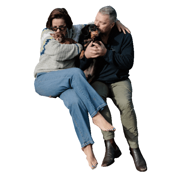 two people in photo are Kate and Tim Brooks from Coorong Life and they’re kissing the dogs Edwin Morris and Brandi Lee Brooks