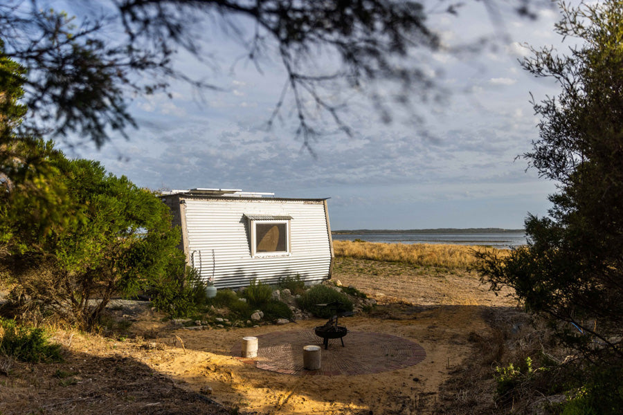 KipPod I nestled among trees with a view of the Coorong and dunes in the background