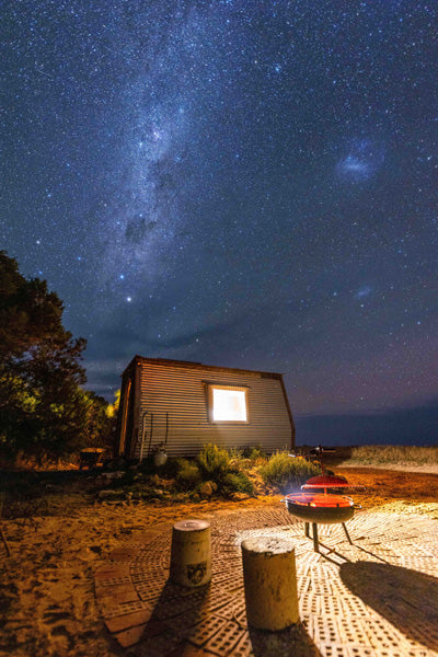 Small cabin called a KipPod under a starry night sky with the Milky Way visible at nature retreat Coorong life in South Australia 